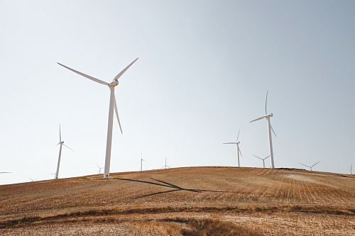 white electric windmills during daytime